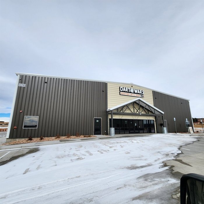 Completed Dart Wars indoor arena exterior, a metal building with a gabled entry canopy
