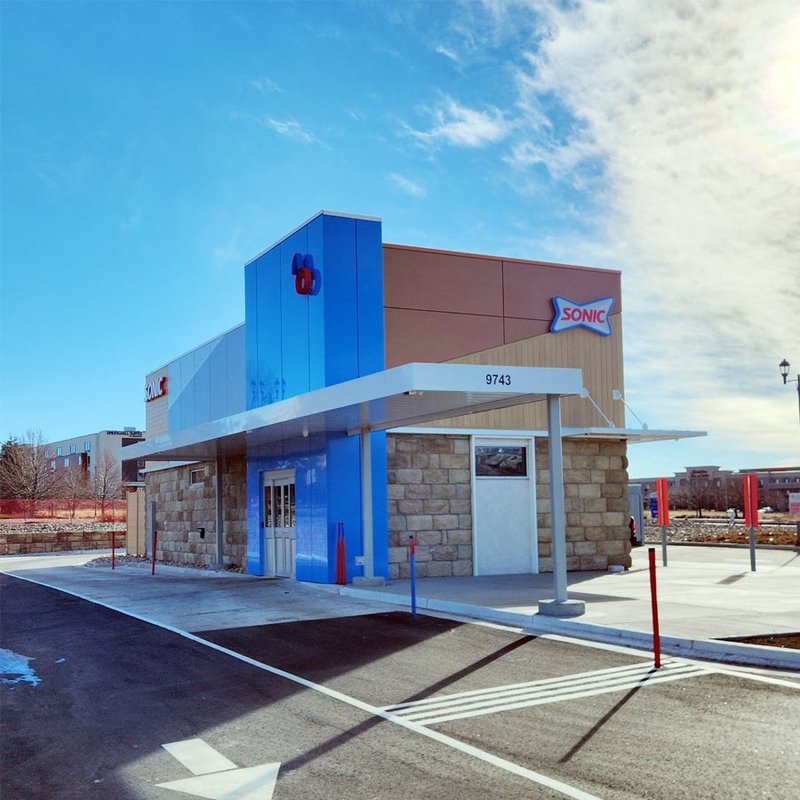 Completed Sonic Drive-In restaurant exterior with blue tower, stone base and drive-in canopy